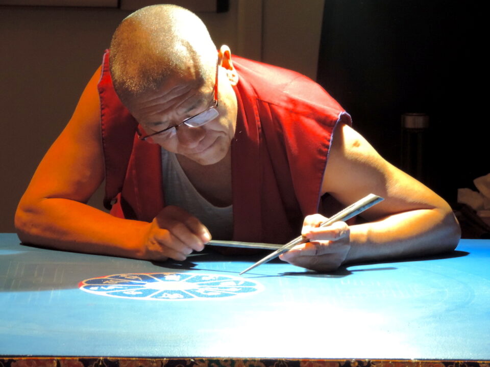 Venerable Legden Gompo forms the sand mandala dedicated to the Buddha Maitreya at the Seaside Center for Spiritual Living in Encinitas on Monday. The group of monks will continue to form the mandala throughout the week. Photo by Abigail Sourwine