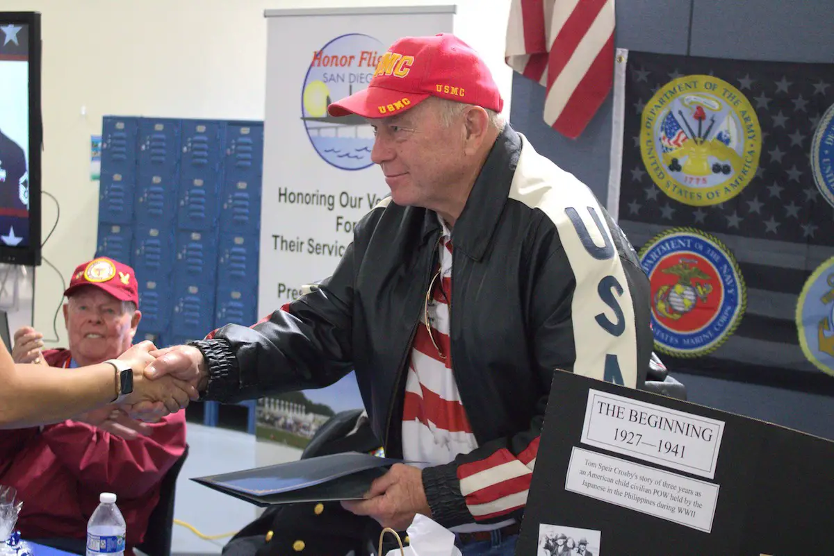 U.S. Navy veteran Peter McBride greets members of Baypoint Preparatory Academy in San Marcos during the school’s Veterans Day event on Nov. 17. Photo by Laura Place