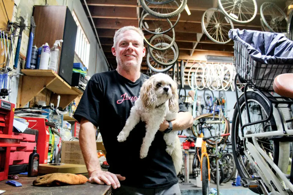 Jeffrey Schade, pictured with his dog Barley, recently acquired Leucadia Cyclery. Photo by Jordan P. Ingram