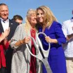 Mayor Rebecca Jones embraces Pia Harris-Ebert, the city’s first female council member and namesake of the new Via Vera Cruz bridge, during a dedication and ribbon-cutting ceremony on Friday. Photo by Laura Place