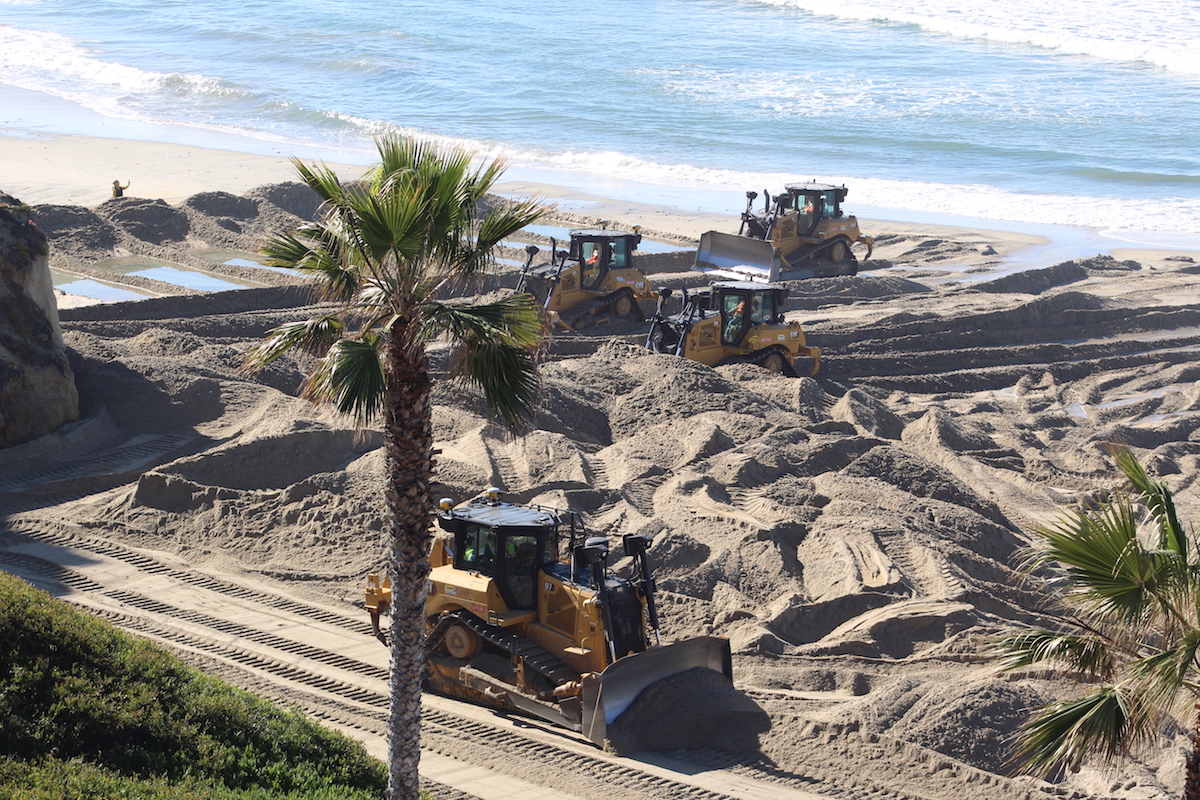 Excavators expand the beach at Fletcher Cove with new sediment brought in via a dredge in the first few days of the Solana Beach’s sand restoration project. Photo by Laura Place
