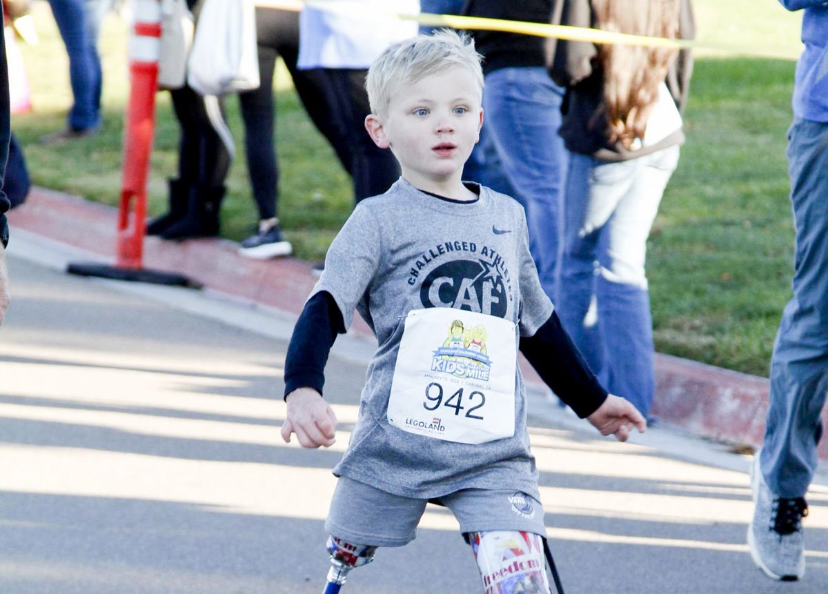 Beauden Baumkirchner, who lost both of his legs after contracting staph, competed in the Kids Marathon Mile on Jan. 13 in Carlsbad. Photo by Finisher Pix/In Motion Events