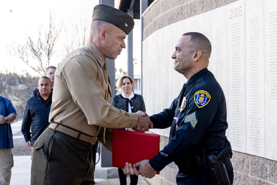 U.S. Marine Corps Col. Daniel Whitley, left, and SDPD Officer Francisco Roman Jr., a Marine veteran, shake hands during a Purple Heart medal award ceremony held on Jan. 23 at Camp Pendleton. Photo by Lance Cpl. Mhecaela J. Watts