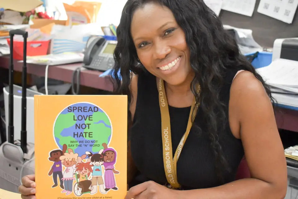 Danner Jantzer, a second grade teacher at Paul Ecke-Central Elementary School, holds her new children's book, “Spread Love Not Hate: Why We Do Not Say the ‘N’ Word." Photo by Samantha Nelson