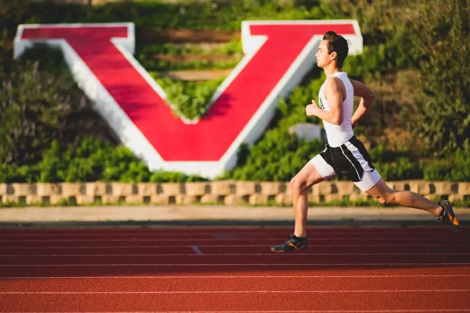 A student competes in a race at Vista High School’s track and field stadium in 2019. The Vista Unified School District will carry out a $5.5 million renovation of the facility this summer. Photo by Frank Lopez