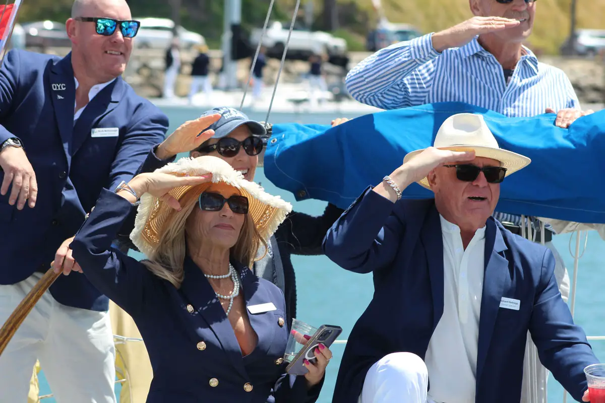 Yacht club members salute the commodores as they drive past them during the Oceanside Yacht Club opening day boat parade. Photo by Samantha Nelson