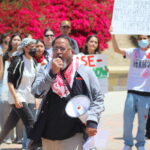 CSUSM ethnic studies director and San Diego Poet Laureate Jason Magabo Perez speaks at a pro-Palestine rally at Cal State San Marcos on Thursday. Photo by Laura Place