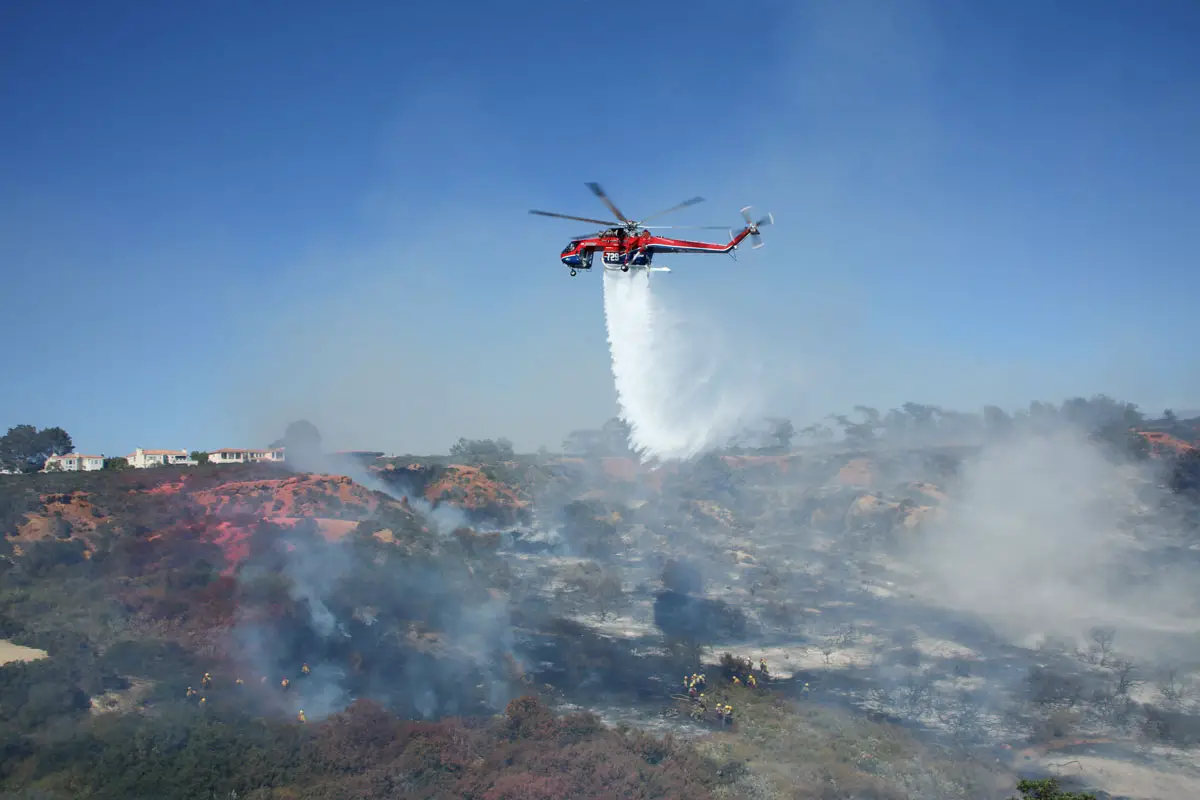 Fire crews battle the flames from the air Tuesday afternoon near Del Mar Heights. Photo by Ryan Grothe