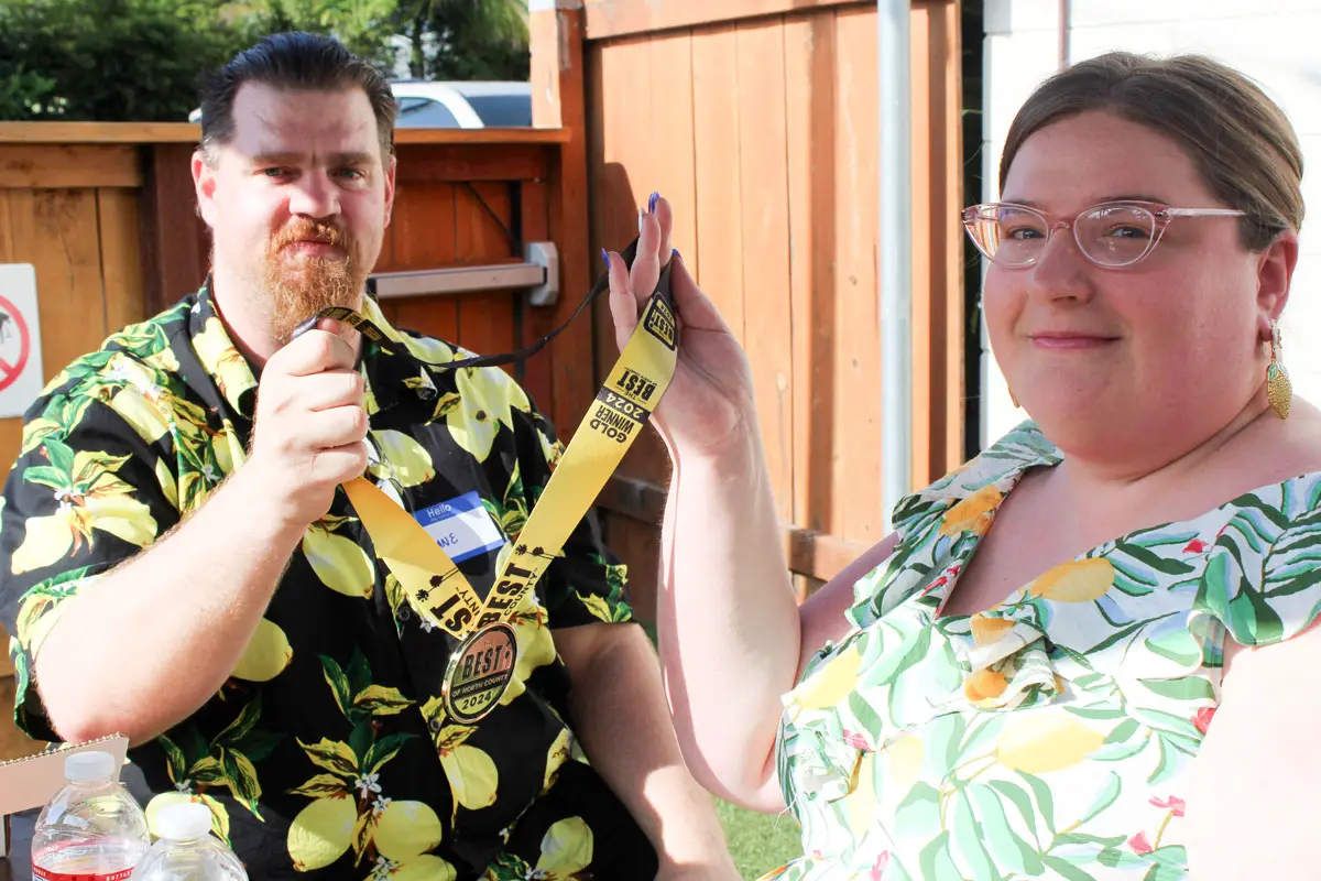 Owners of Allen Brothers Mortuary, with locations in San Marcos, Vista and San Diego, hold up their gold medals for Best Funeral Home Services. Photo by Chris Kydd