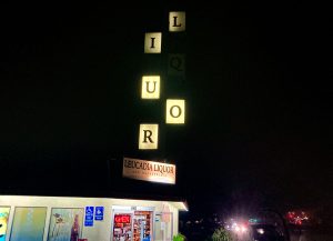 The famous missing letter "Liquor" sign at Leucadia Liquor. Photo by David Boylan