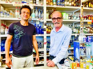 Kamil and Tony behind the counter of Leucadia Liquor. Photo by David Boylan