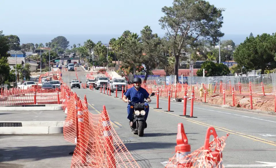 Dr. Nikolas Capetanakis, known locally as Dr. Cap, has delivered over 4,000 babies at Scripps Encinitas. He has bought a moped to quickly navigate the increased traffic due to construction on the delayed Santa Fe Drive corridor improvement project.