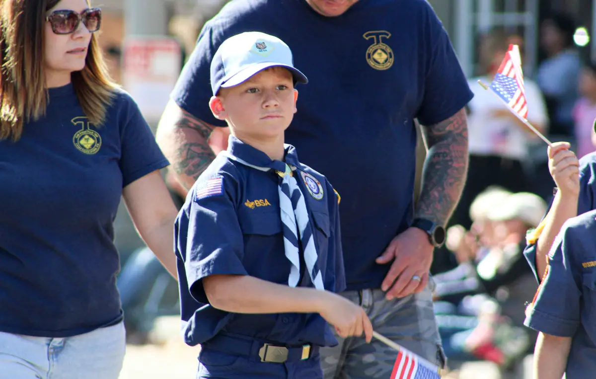 A Boy Scout waves a flag during a Veterans Day Parade on Nov. 11 in Fallbrook. Photo by Samantha Nelson