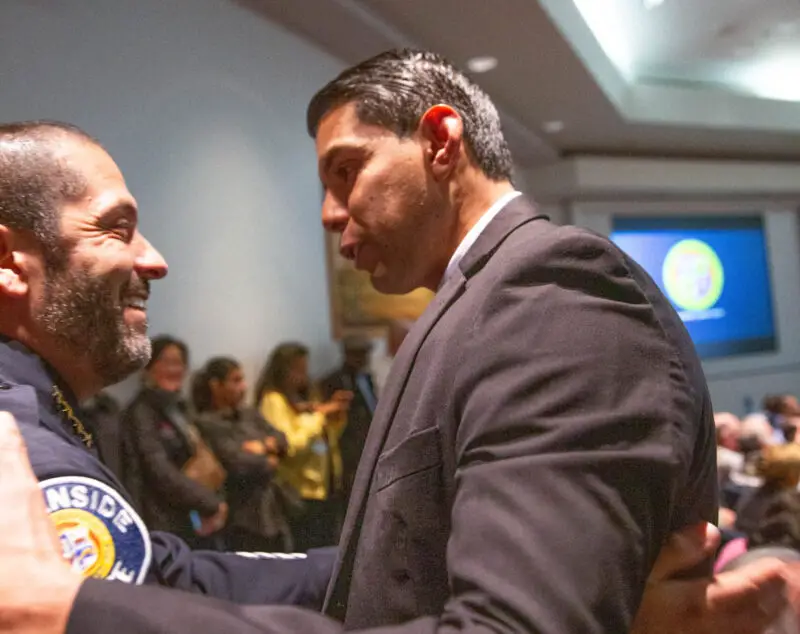 Oceanside Police Chief Taurino Valdovinos congratulates Councilmember Jimmy Figueroa at his swearing-in ceremony on Dec. 11. Valdovinos took over as the city’s newest police chief exactly a month prior to Figueroa assuming office. Photo by Andres X | MadStrange.