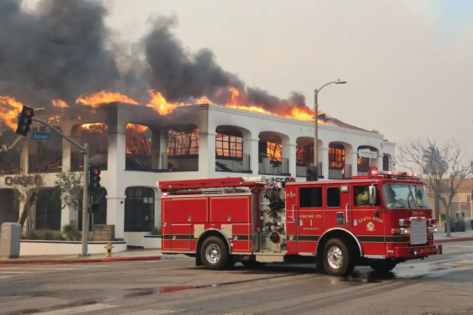 A fire burns a building on Sunset Boulevard in the Pacific Palisades neighborhood of Los Angeles. Photo by Cal Fire