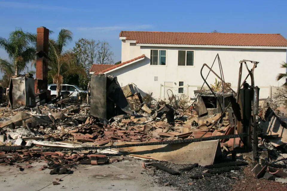 A home in the Rancho Bernardo neighborhood was reduced to blackened rubble during the Witch Fire in 2007. Photo by Kevin Key