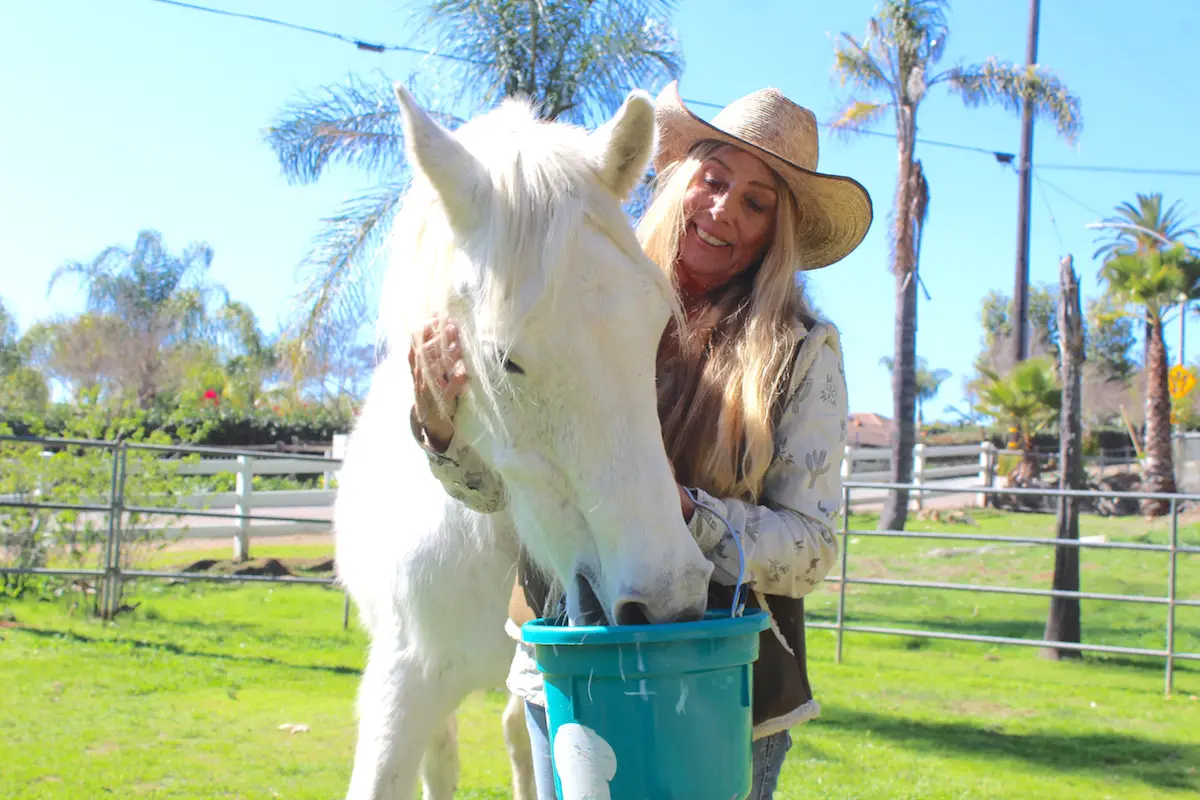 Bheau View Ranch owner Shera Sandwell spends time with horse Bheaujest at her San Marcos property in February. Photo by Leo Place
