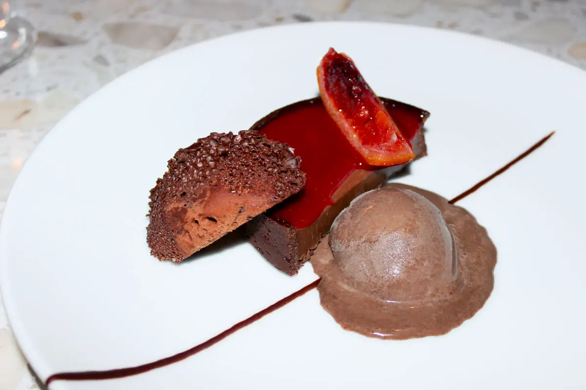 Caramelized milk chocolate tart with burnt orange gel, candied blood orange, and whipped chocolate “aero” that I paired with 2023 UV Lucky Well Pinot Noir. Photo by Rico Cassoni
