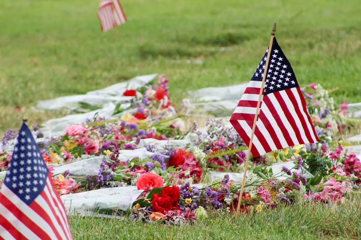 A miniature American flag and flowers rest near gravesites on May 26 during a Memorial Day ceremony at the Fallbrook Masonic Cemetery. Photo by Samantha Nelson 