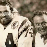 Dan Fouts, left, shares time with Dr. Richard Gilbert, during a San Diego Chargers game in 1984. Fouts and other ex-Chargers remain close to Encinitas’ Gilbert as he nears his 98th birthday. Courtesy photo