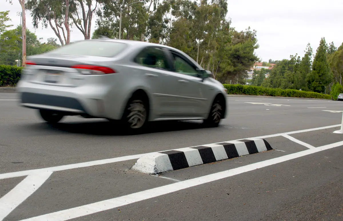 New protected bike lanes with striping, berms and delineators have been installed along arterial roads in Vista like Melrose Drive, earning mixed reviews from residents. Photo by Leo Place