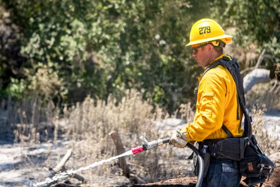 A firefighter with the Camp Pendleton Fire Department performs mop-up procedures in 2020. Photo by Lance Cpl. Drake Nickels