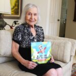 Naomi Pruzansky, 99, pictured Monday at her Rancho Santa Fe home, wrote children’s book “A Jet Set Pet Named ‘Penny’” about the travels of her granddaughter’s Boston terrier. Photo by Leo Place