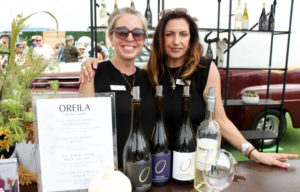 Orfila Tasting Room manager Stacy Melow, left, and Bernece Di Carlo pour four wines at the Brandt Beef exhibition in Del Mar. Photo by Rico Cassoni
