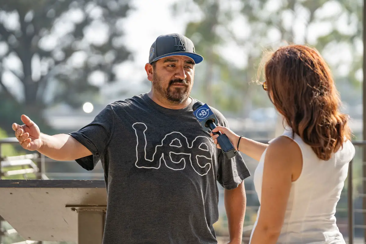 Resident Mario Aquilar speaks to a local news reporter outside City Hall on Tuesday in Carlsbad. Several residents expressed their views about proposed regulations of e-bikes in the city. Photo by Tanya Perez