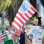Protesters gather outside Escondido City Hall during a “Workers Over Billionaires” rally on Labor Day. Photo by Samantha Nelson