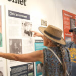 Visitors react to panels at the new Oceanside History Center. Photo by Samantha Nelson
