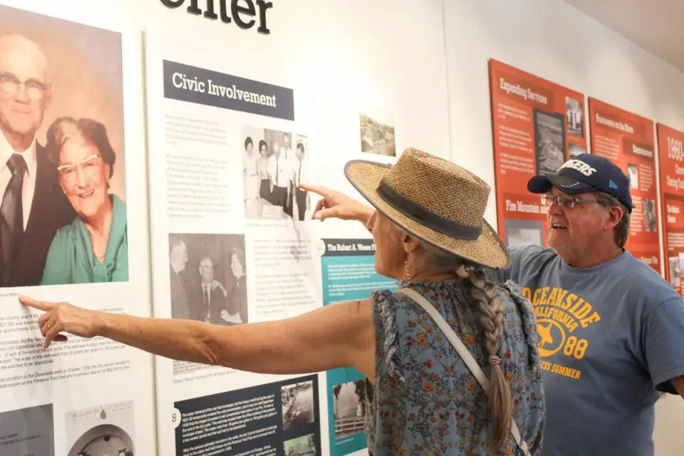 Visitors react to panels at the new Oceanside History Center. Photo by Samantha Nelson