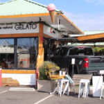 A truck struck another car and then drove into the Gelato 101 building on Wednesday night, injuring a child. The truck was still present Thursday morning. Photo by Leo Place