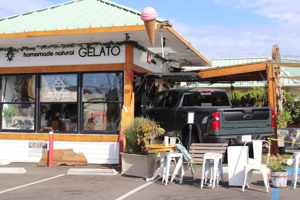 A truck struck another car and then drove into the Gelato 101 building on Wednesday night, injuring a child. The truck was still present Thursday morning. Photo by Leo Place