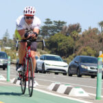 A cyclist rides in Cardiff-by-the-Sea, where the city has installed a disabled parking space and short-term parking along San Elijo Avenue. File photo/Jordan P. Ingram