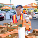 Feeding San Diego volunteer Barb Boon prepares food for distribution at Palomar College in December 2023. File photo/Leo Place
