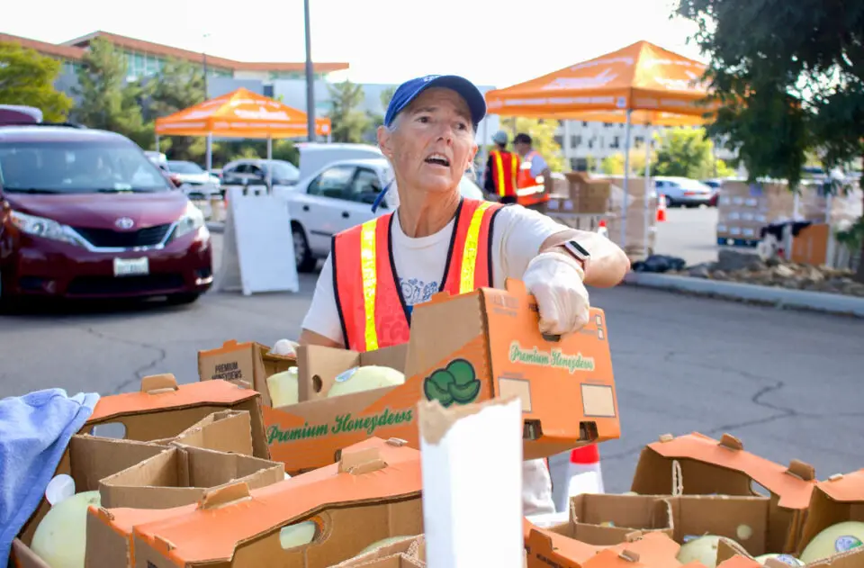 Feeding San Diego volunteer Barb Boon prepares food for distribution at Palomar College in December 2023. File photo/Leo Place