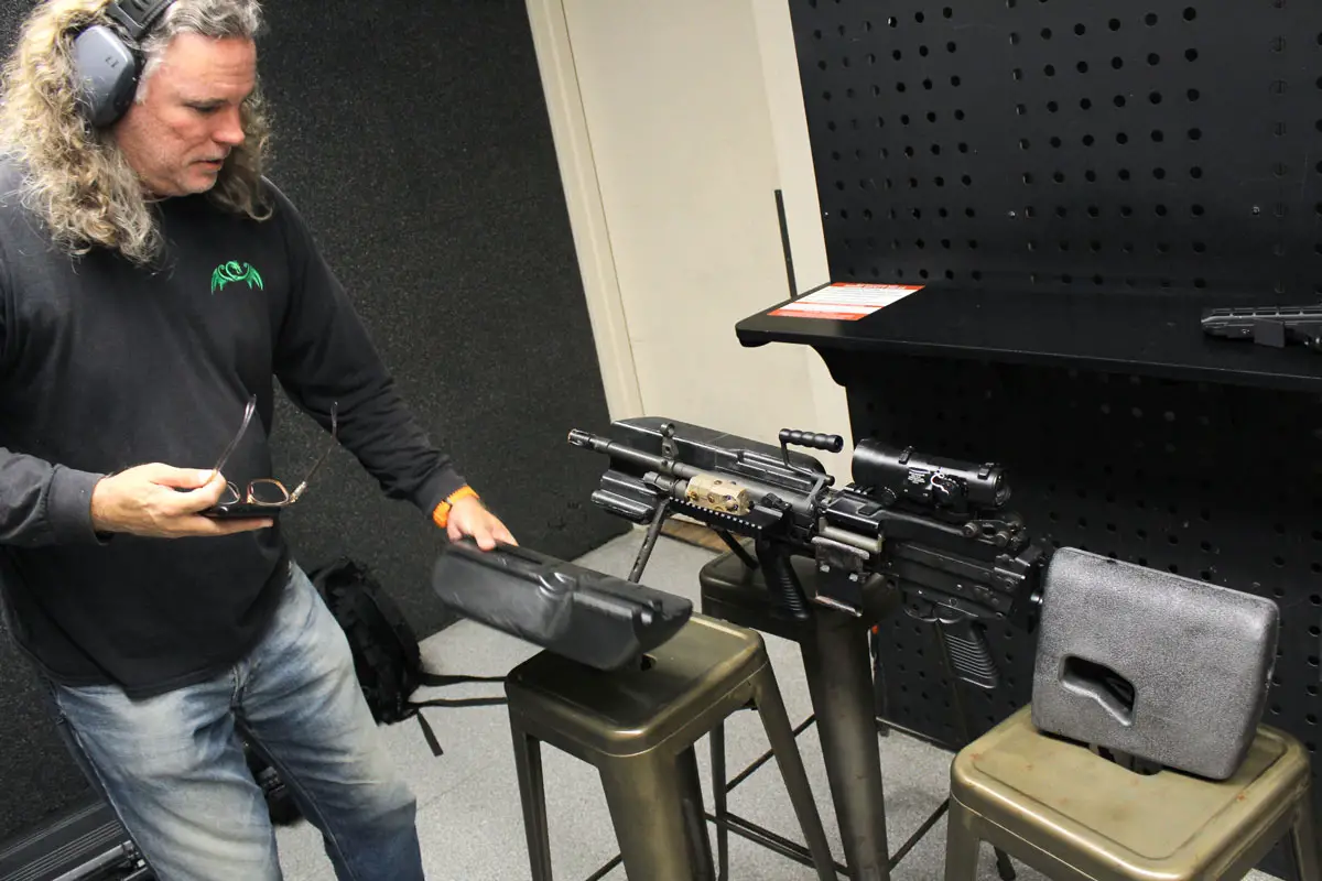 David Ondash, co-founder of Green Dragon Ventures, demonstrates the flotation device on a replica Mark 48 machine gun. The device keeps weapons buoyant in water, making it easier to carry out operations that go from sea to land. Photo by Cameron Adams