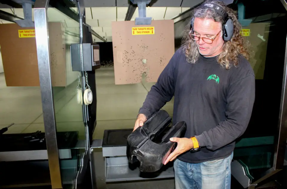 David Ondash, co-founder of Green Dragon Ventures, demonstrates the Weapons Flotation Device on a replica Mark 48 machine gun. Photo by Cameron Adams