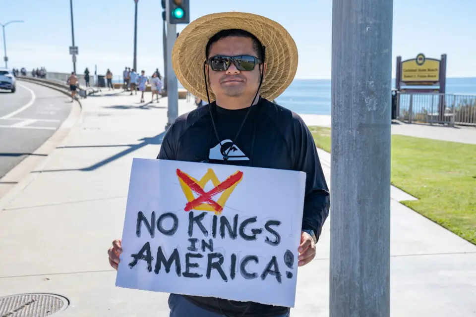 Carlsbad resident Adrian Cordova holds a sign during a "No Kings" protest on Oct. 17 in Carlsbad. Photo by Tanya Perez