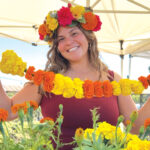 Erin Rodriguez wears a crown of marigolds at Mellano Farm Stand on N. River Road in Oceanside, which is hosting a Día de los Muertos Celebration on Oct. 18-19. Courtesy photo