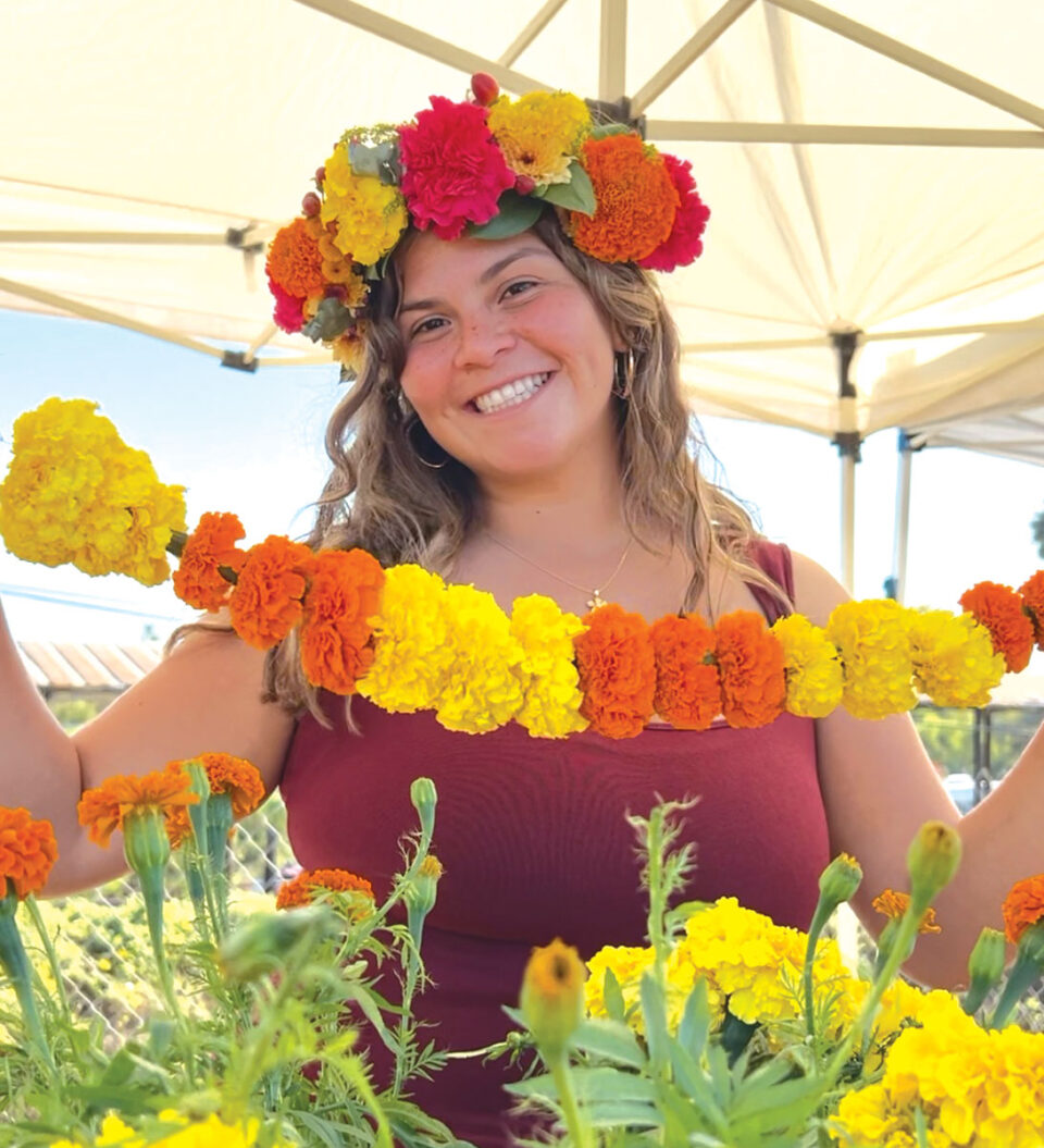 Erin Rodriguez wears a crown of marigolds at Mellano Farm Stand on N. River Road in Oceanside, which is hosting a Día de los Muertos Celebration on Oct. 18-19. Courtesy photo