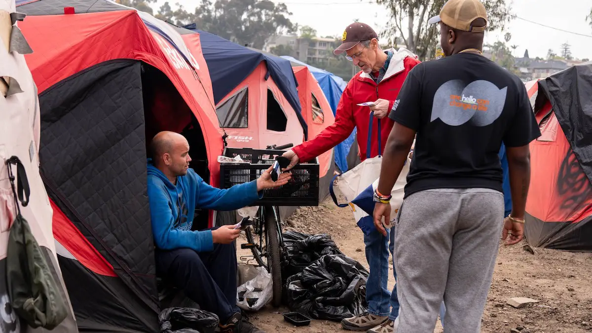 San Diego Rescue Mission outreach workers provide socks to unhoused individuals. Courtesy photo/San Diego Rescue Mission