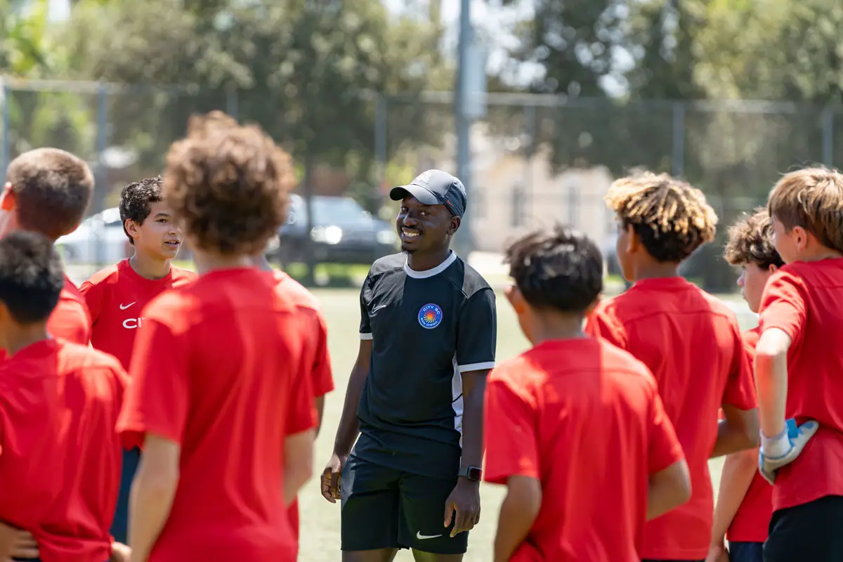 City SC Carlsbad coach Tapiwa “Taps” Manhungo smiles during warmups at a recent team practice in Carlsbad. Photo by Tanya Perez