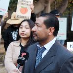 Just Peachy owner Norberto Ambrosio Sr. speaks to media outlets in front of the federal courthouse on Nov. 25 in San Diego. Photo by Cameron Adams