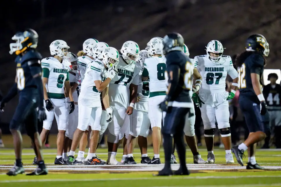 Oceanside players huddle before a play during the Battle of Oceanside rivalry game against El Camino on Oct. 30 at Herb Meyer Stadium. Photo by Lajos Kamocsay