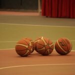 5 basketballs sitting on a court