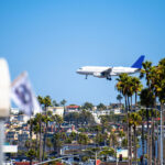A passenger jet approaches San Diego International Airport. Federal flight capacity reductions begin taking effect nationwide today, leading to dozens of delays and cancellations across Southern California. Photo by Frimu Eugen