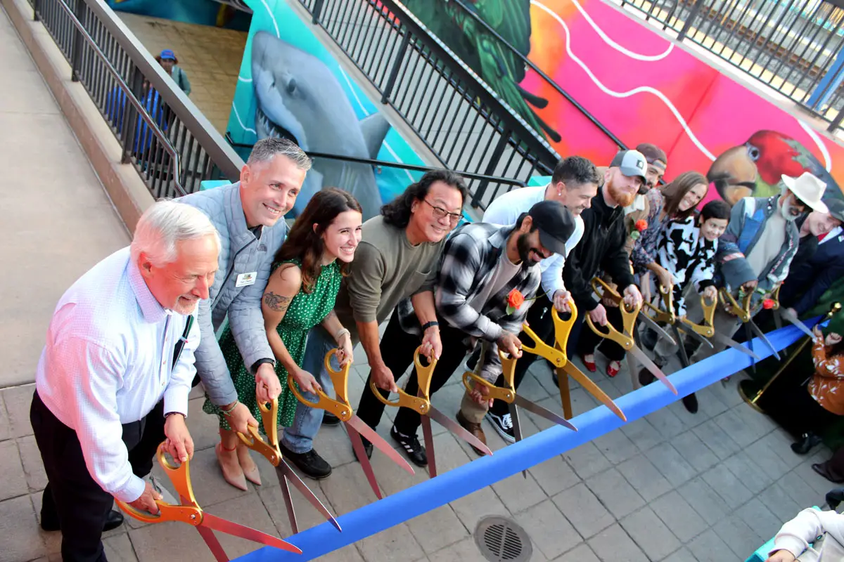 Artists and NCTD representatives cut the ribbon in celebration of the completed pedestrian tunnel mural at the Oceanside Transit Center. Photo by Samantha Nelson