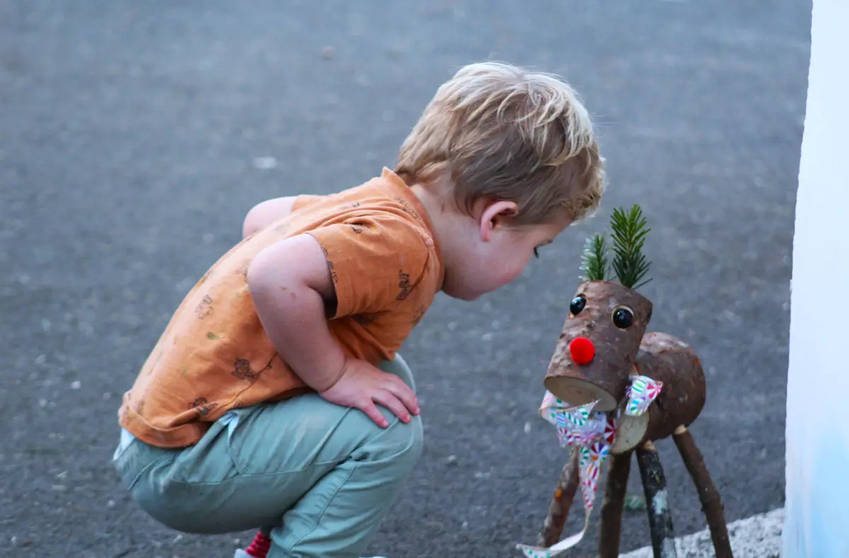 A young visitor makes a friend at the Purdy Tree Farms lot at the Del Mar Fairgrounds on Tuesday. Photo by Leo Place